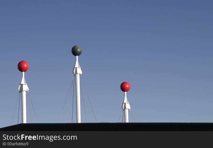 Three Rooftop Poles In Front Of Clear Blue Sky, Background