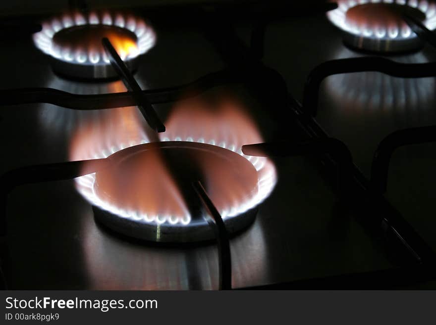 Blue Flame Of A Stove Burner In Darkness Illustrating Combustion Of Gas. Blue Flame Of A Stove Burner In Darkness Illustrating Combustion Of Gas