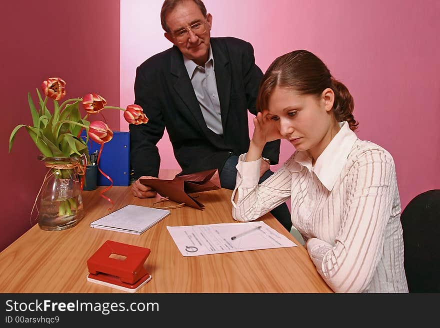 Work environment- man bringing some gift for a woman working in office