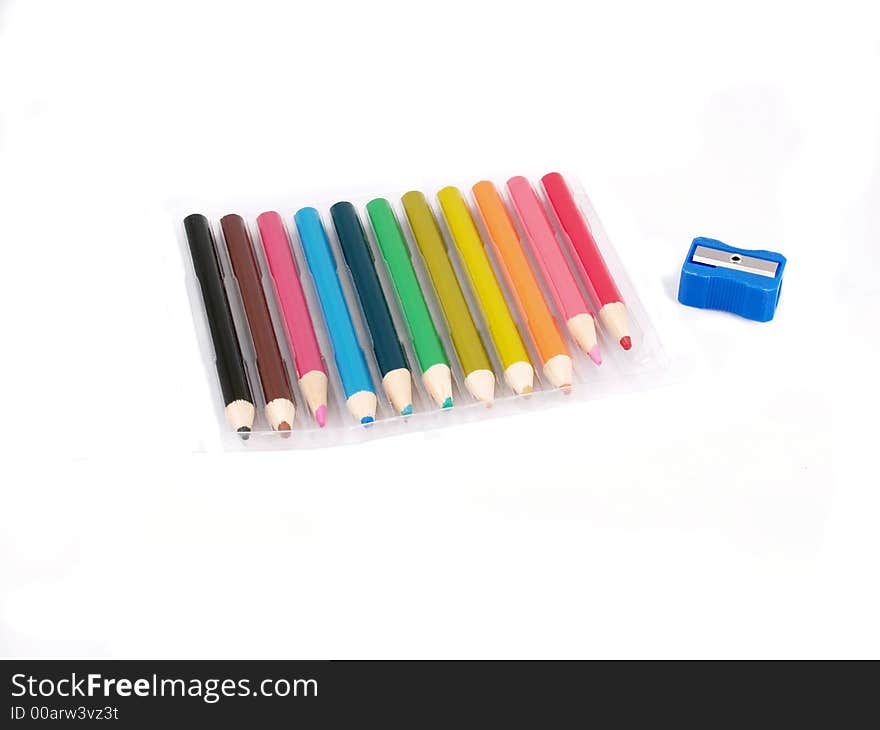 Short colored pencils in a plastic tray with a sharpener