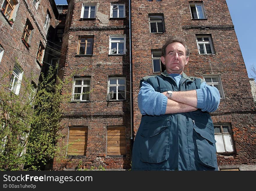 Man in front of ruined house