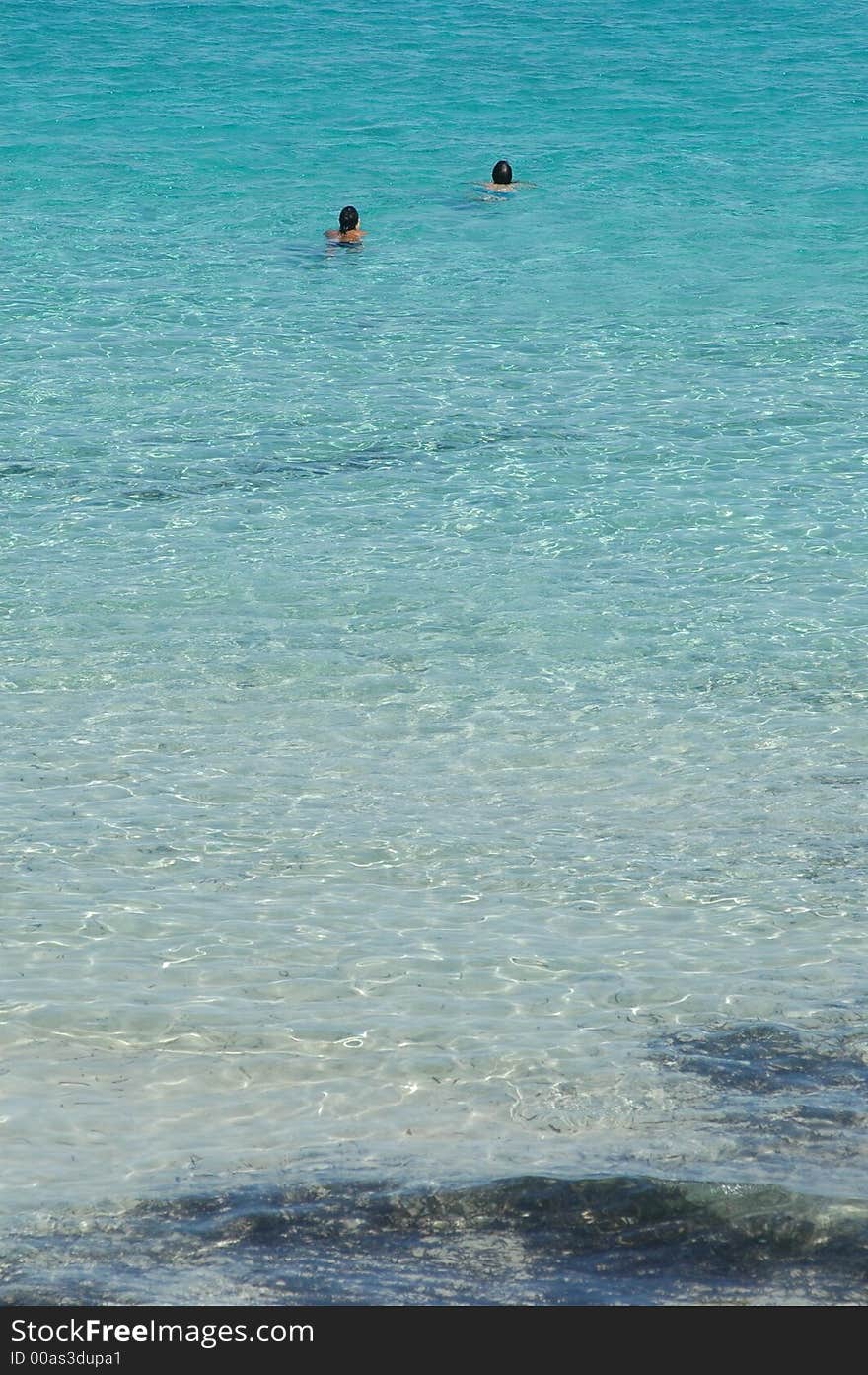 People swimming in wonderful italian sea in Sardinia