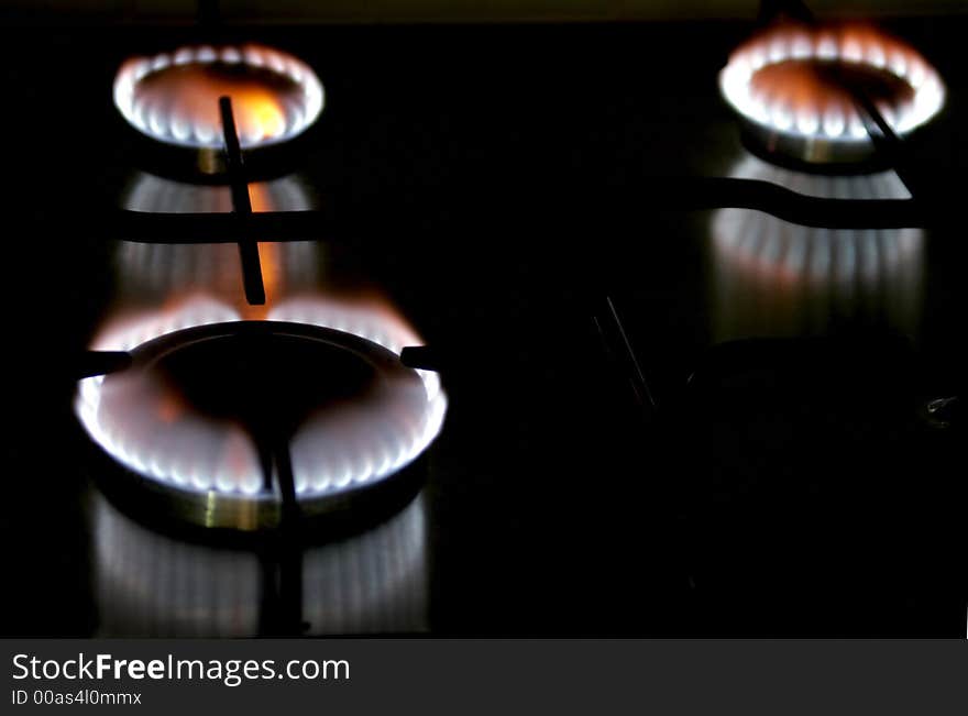 Blue Flame Of A Stove Burner In Darkness Illustrating Combustion Of Gas. Blue Flame Of A Stove Burner In Darkness Illustrating Combustion Of Gas