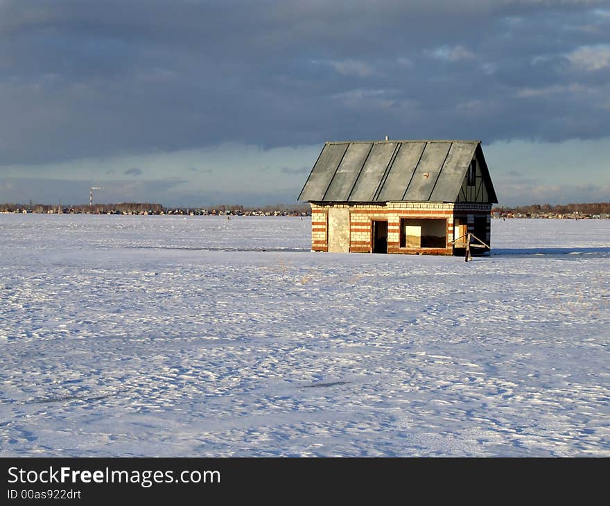 Winter lake with the flooded house on a background of the sky. Winter lake with the flooded house on a background of the sky.