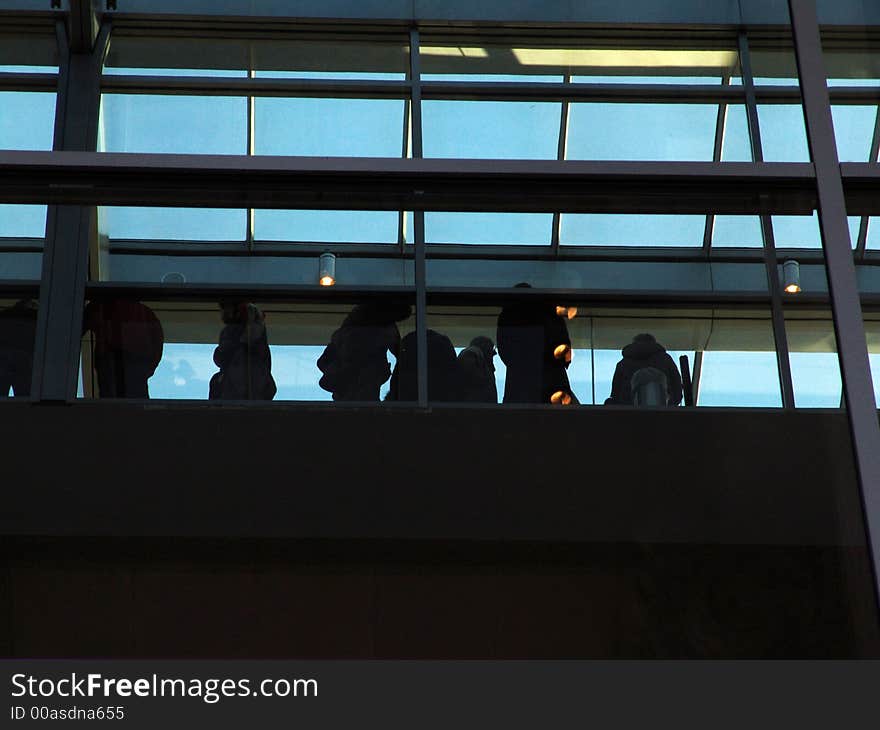 A crowd inside a modern building. A crowd inside a modern building