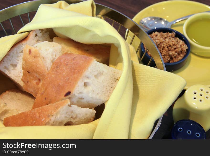 Basket of bread with olive oil and deep fried shallots. Basket of bread with olive oil and deep fried shallots