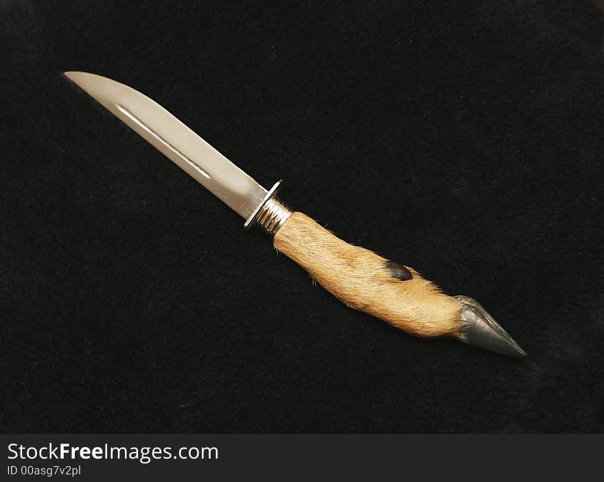 Souvenir hunting knife with the handle from a leg of a goat