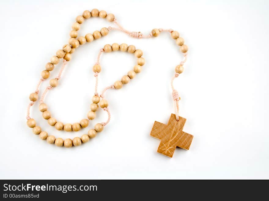 Wooden rosary on a white background. Wooden rosary on a white background