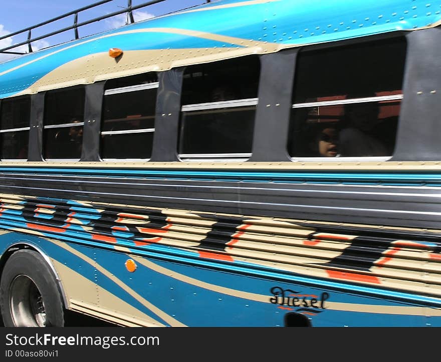 A blue bus mouving fast in antigua