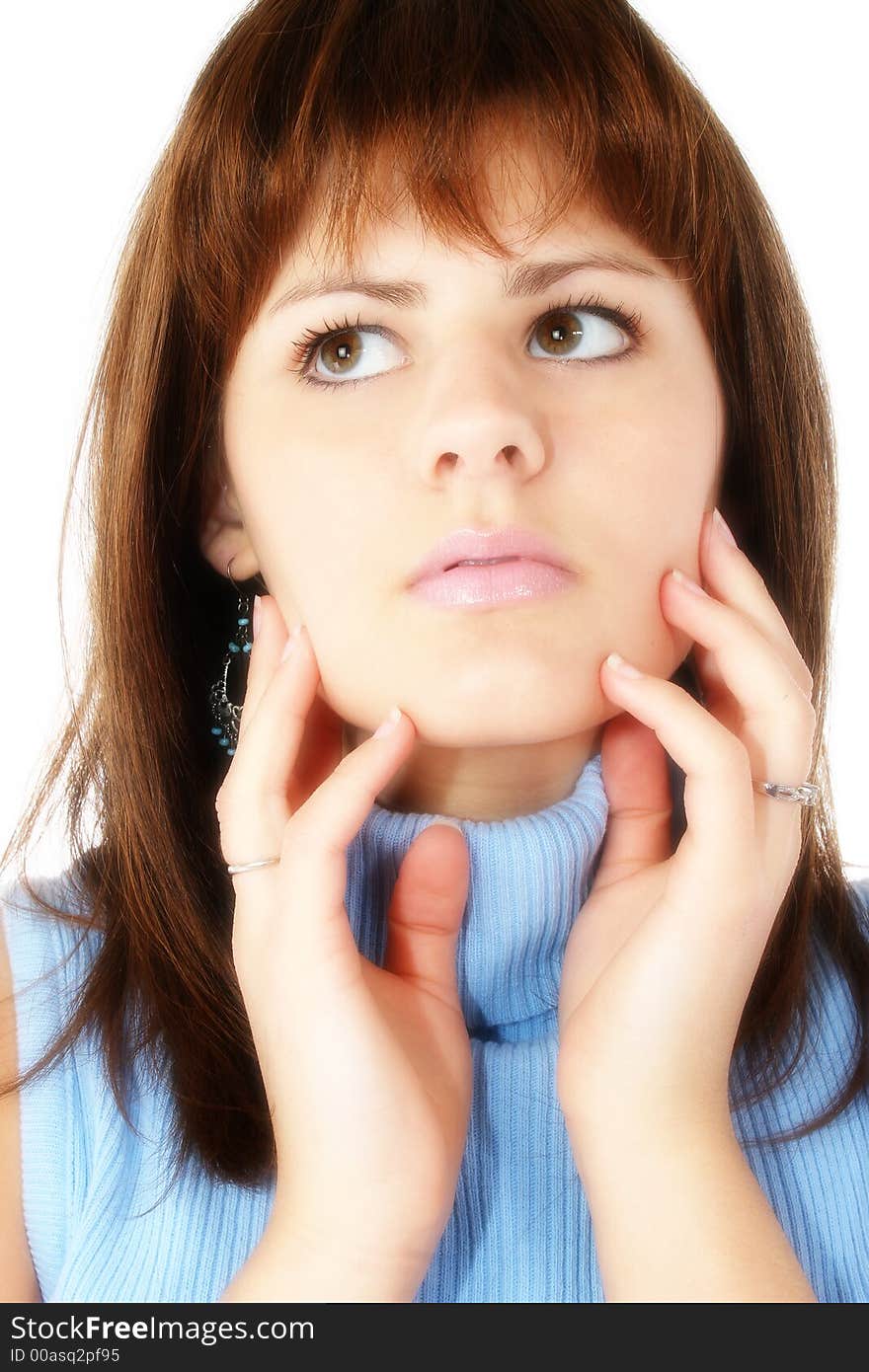 Close up of beautiful young woman in blue.  Hands on face.