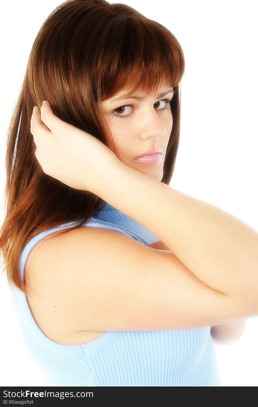 Beautiful young woman with hand in hair.