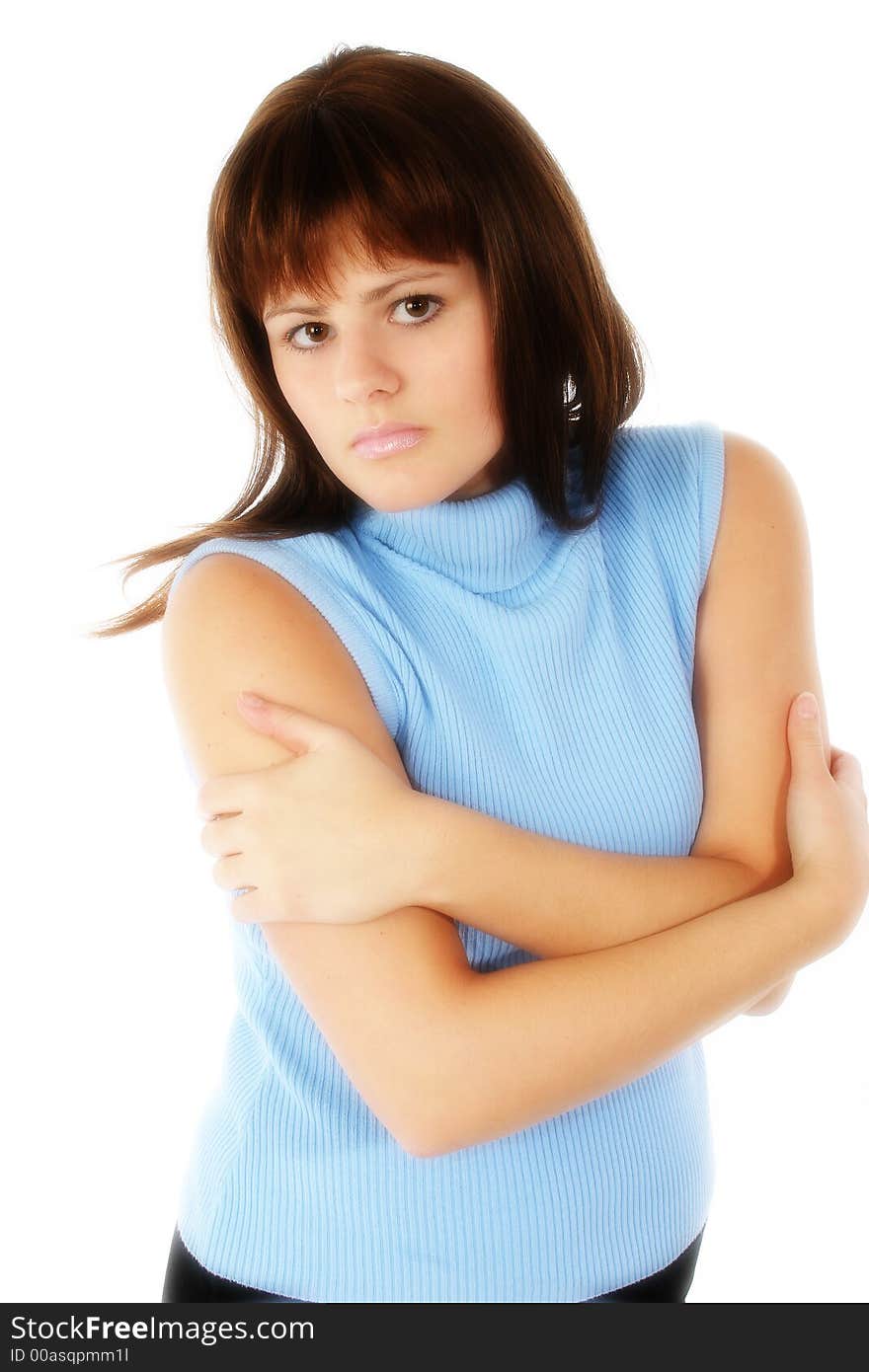 Beautiful young woman with arms crossed. Serious expression,