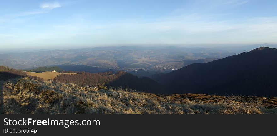 Mountain panorama with small town on background. Mountain panorama with small town on background