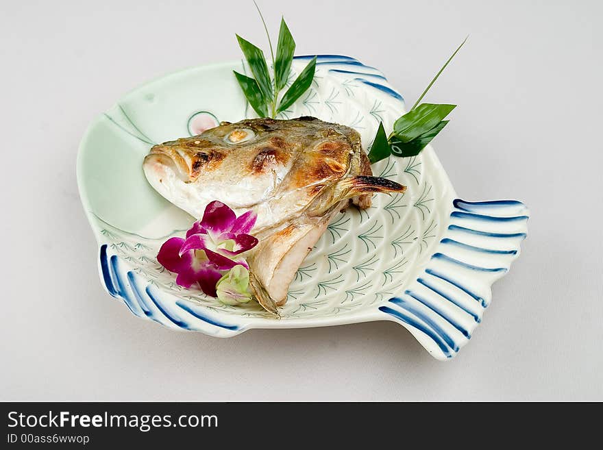 A fish dish with fish head. A fish dish with fish head