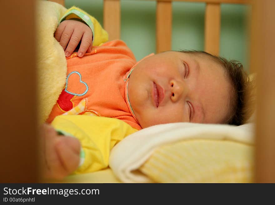 Sleeping newborn baby in the bed