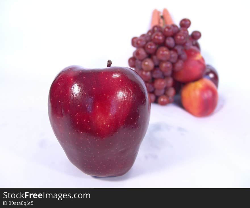 A bunch of fruit and vegetable, including, carrot, apple, apricot and grapes