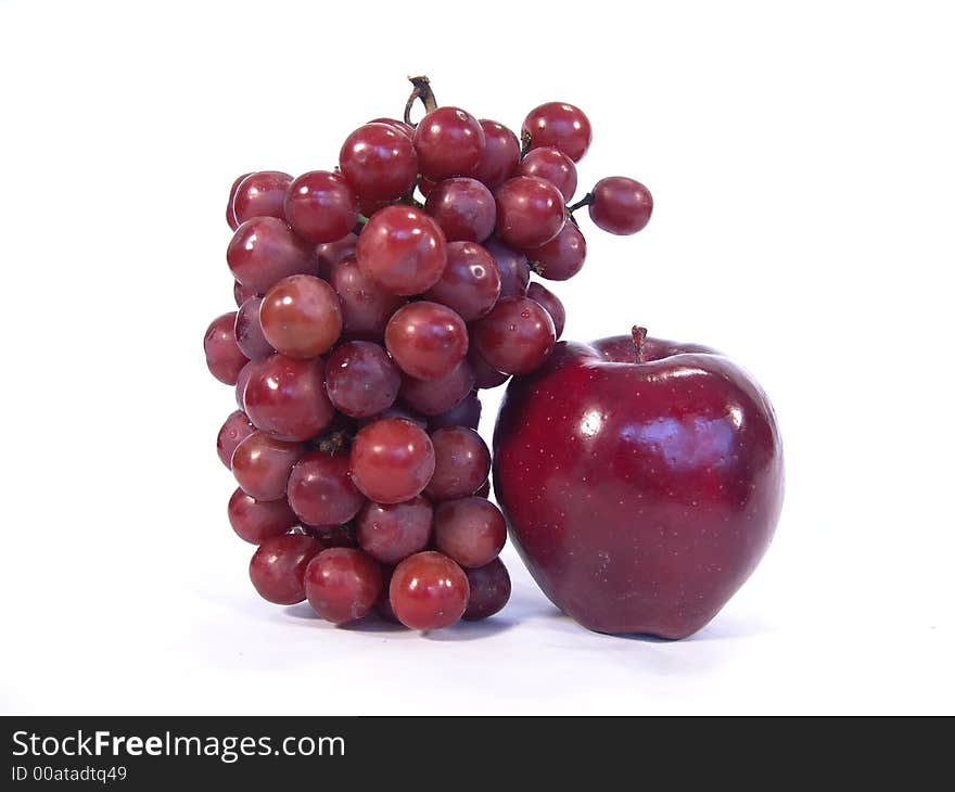 Apple and a bunch of grapes close up view. Apple and a bunch of grapes close up view