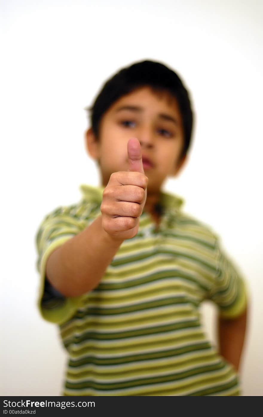 A boy showing thumbs up for his approval