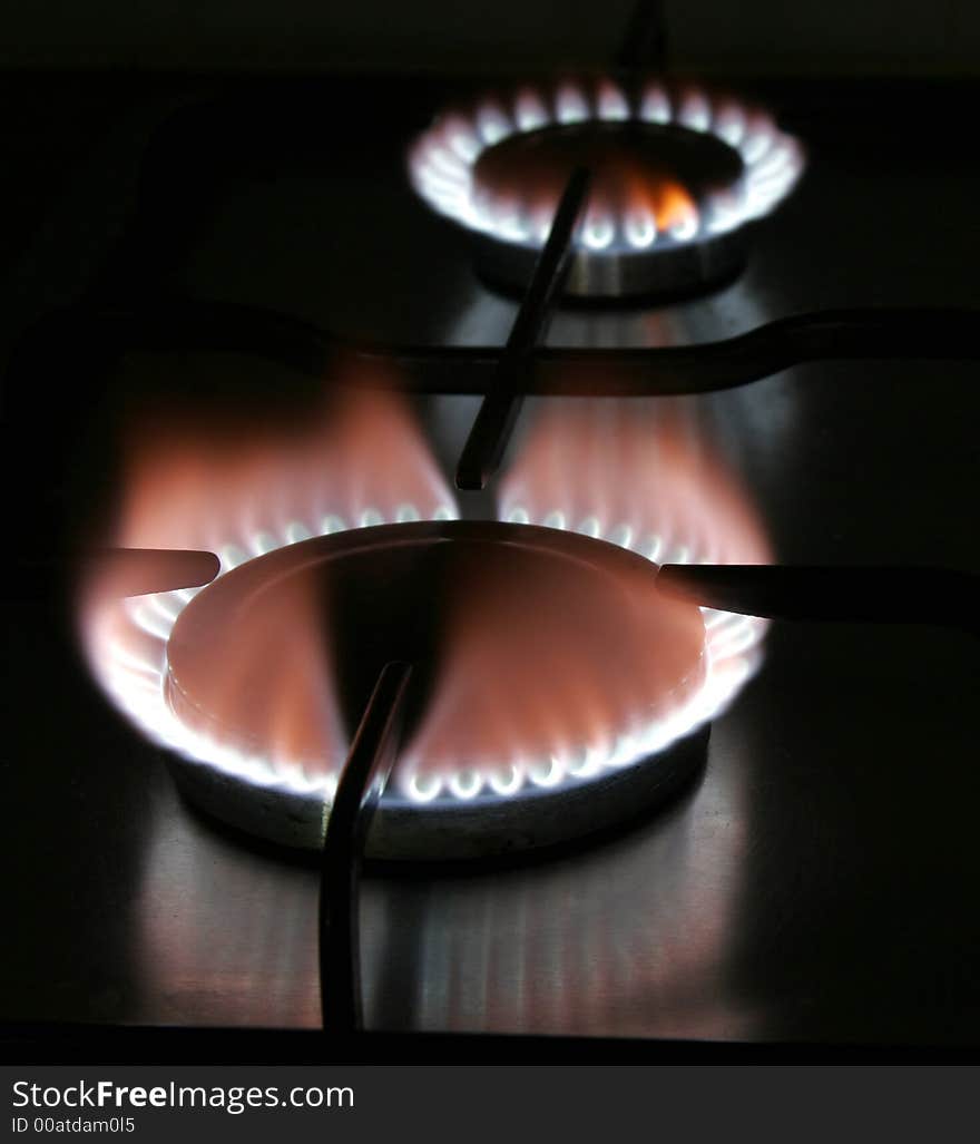 Blue Flame Of A Stove Burner In Darkness Illustrating Combustion Of Gas. Blue Flame Of A Stove Burner In Darkness Illustrating Combustion Of Gas