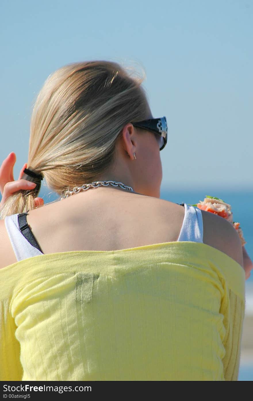 Woman eating a sandwich.