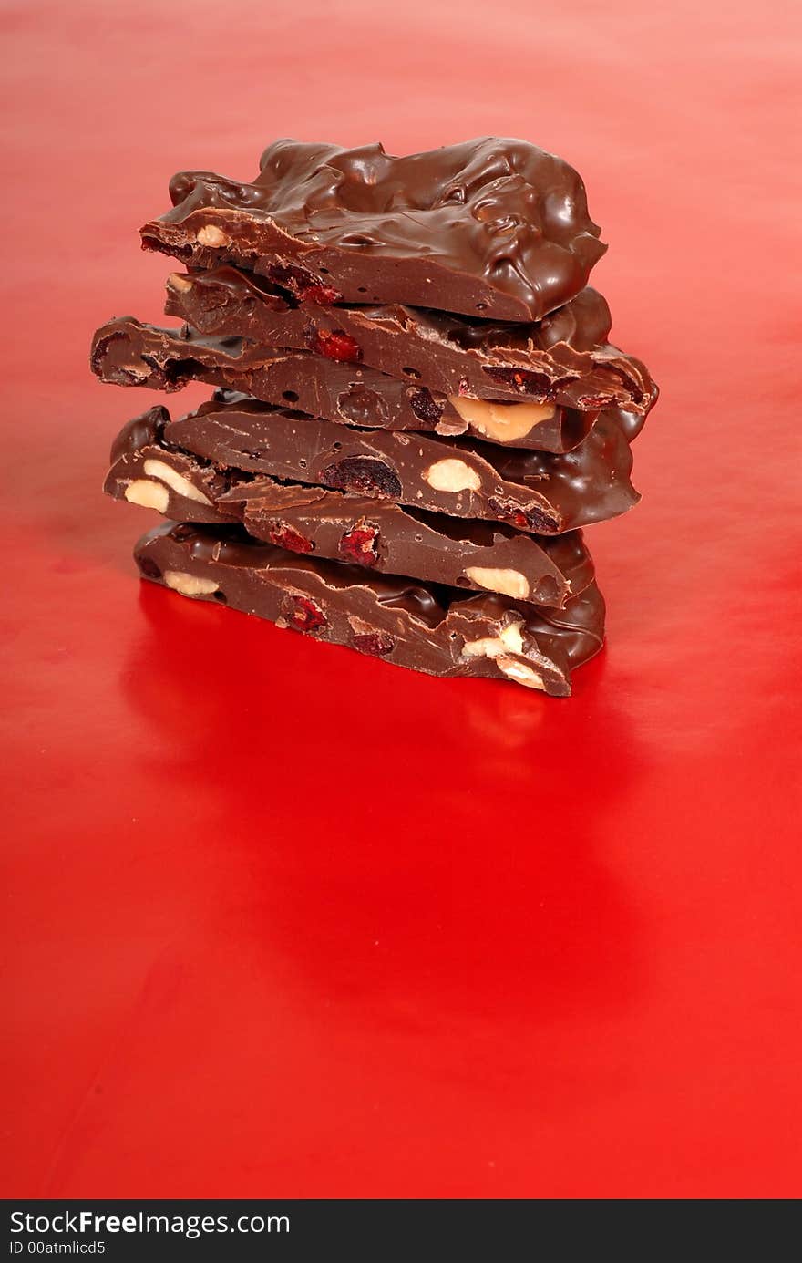 Chocolate cashew and dried cherry bark on a red background