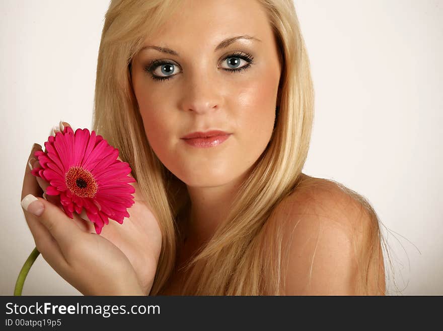 Beautifull woman with red flower in her hands