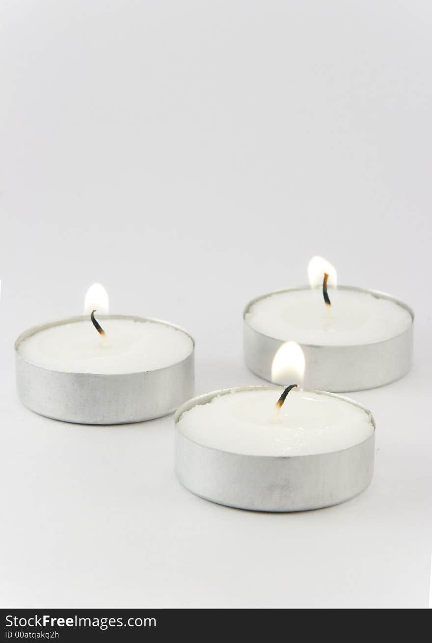 Three candles ignited with a space on them to write