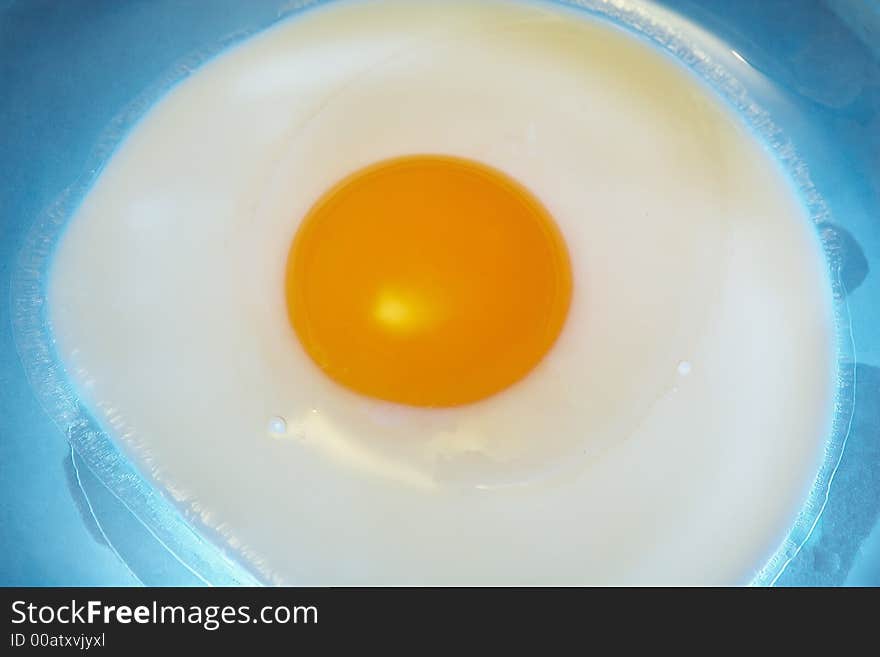 One egg on a blue plate made from glass