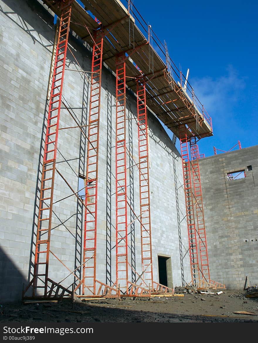 A construction site with ladders and a blue sky background. A construction site with ladders and a blue sky background