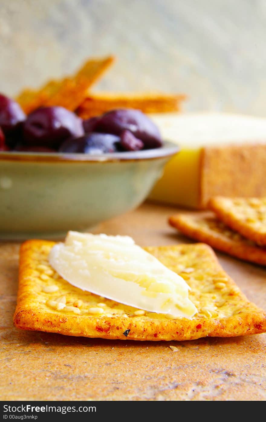 Closeup of cheese and cracker, with Gourmet Olives. Closeup of cheese and cracker, with Gourmet Olives