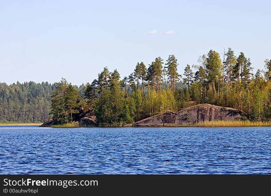 Bright a wood island in the center of lake. Bright a wood island in the center of lake