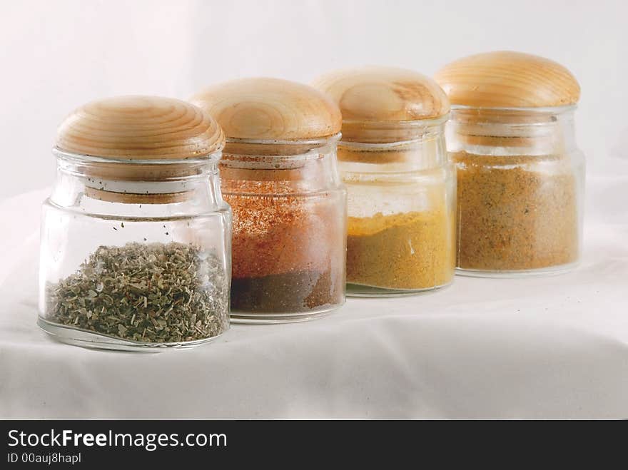 Jars with different spices in a row