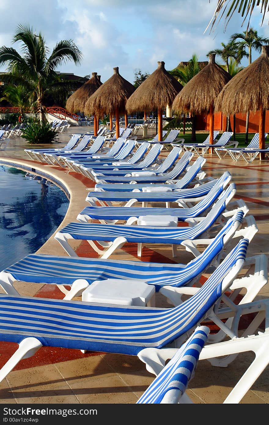 Long chairs surrounding the swimming pool