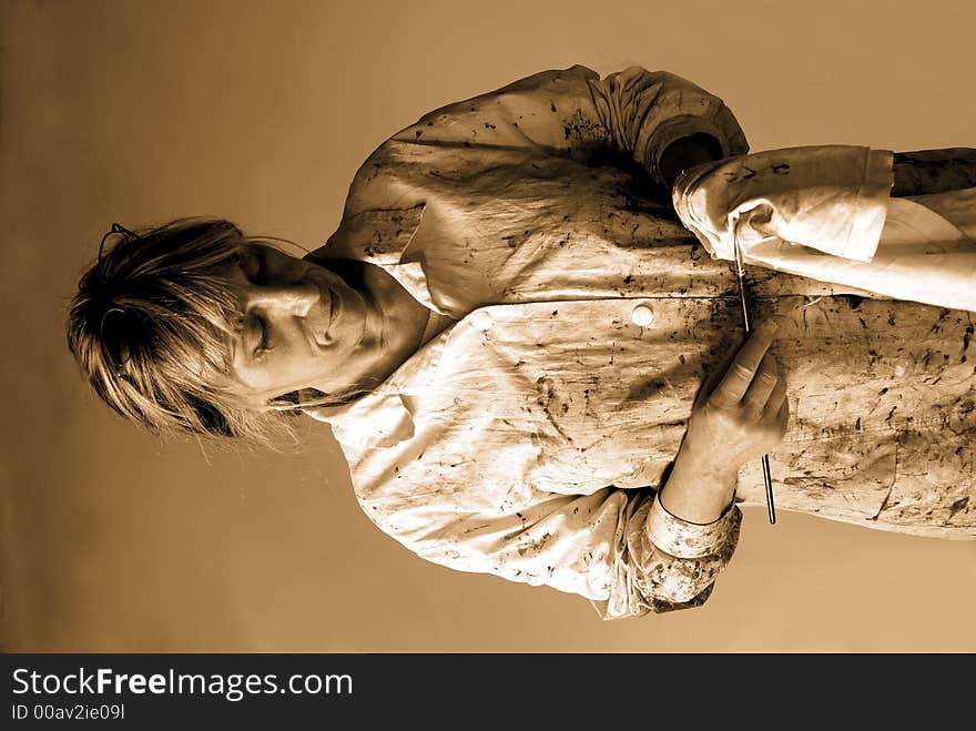 The painter wipes her brush on a piece of cloth (sepia shot). The painter wipes her brush on a piece of cloth (sepia shot)