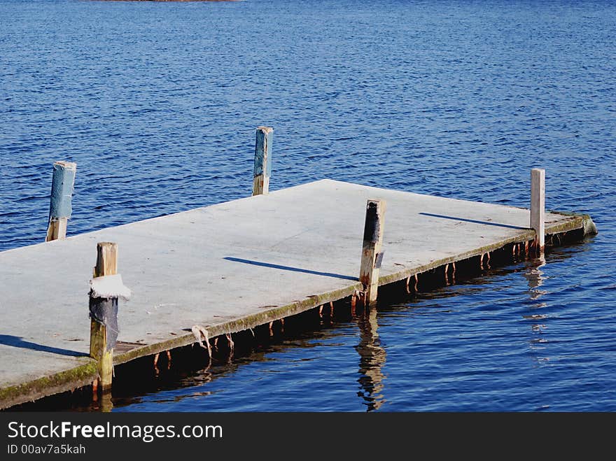 Worn boat dock on lake. Worn boat dock on lake.