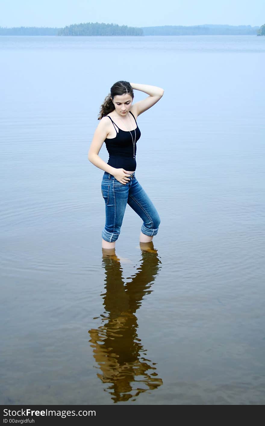 Girl standing in shallow water. Girl standing in shallow water