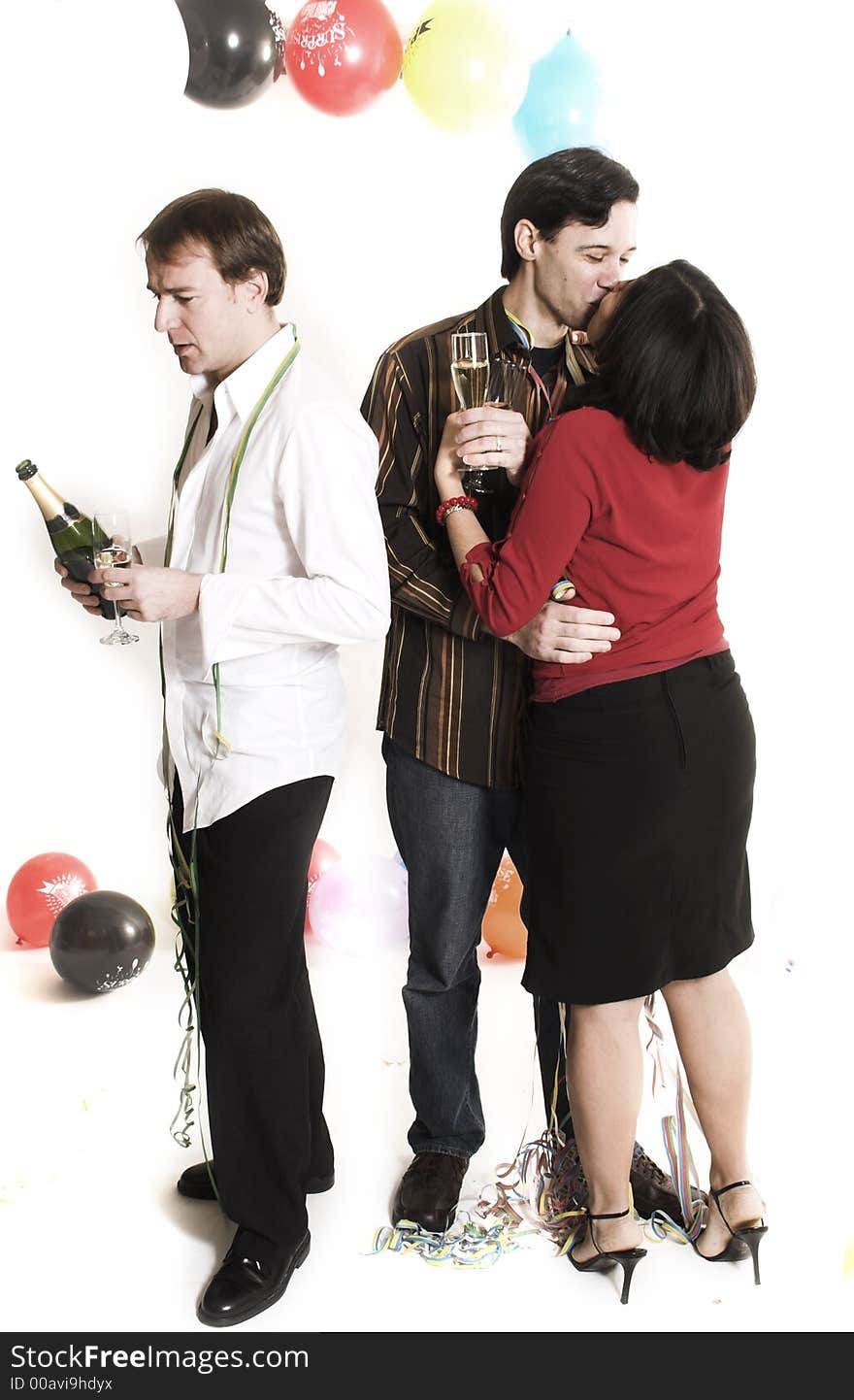 Couple kissing next to single man drinking. Couple kissing next to single man drinking