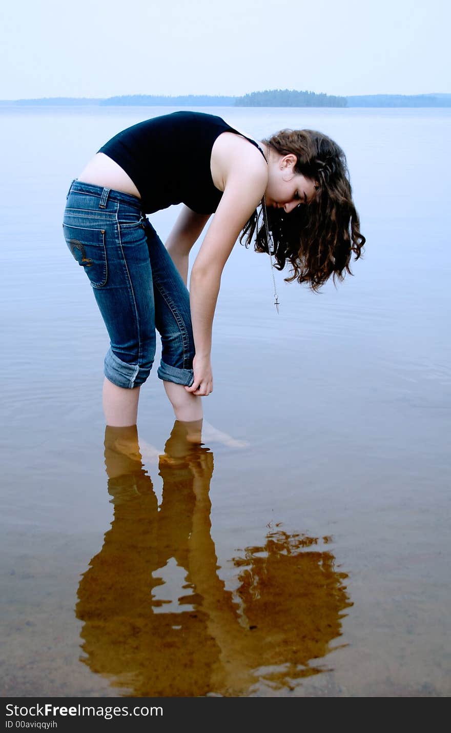 Girl standing in shallow water. Girl standing in shallow water