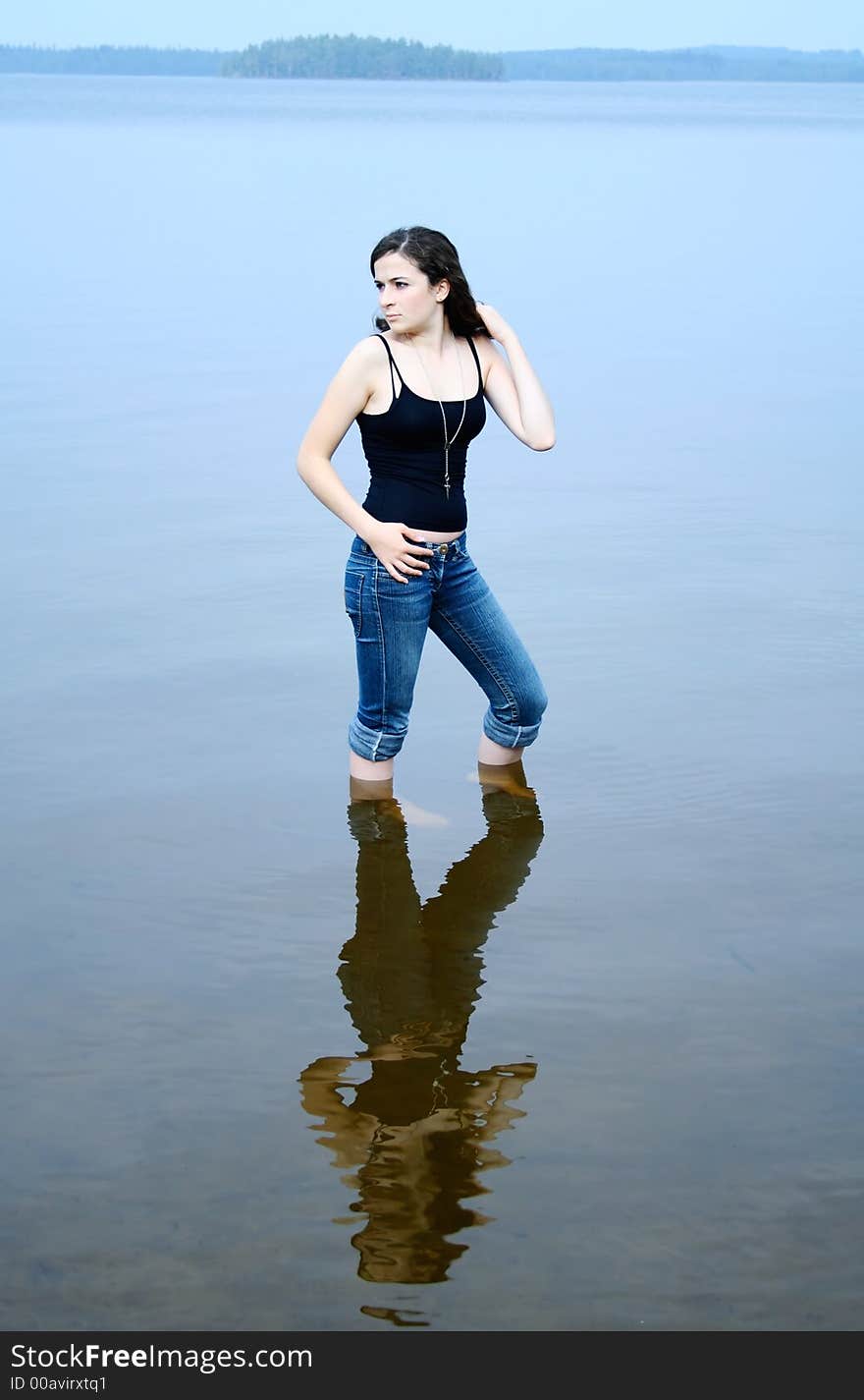 Girl standing in shallow water. Girl standing in shallow water