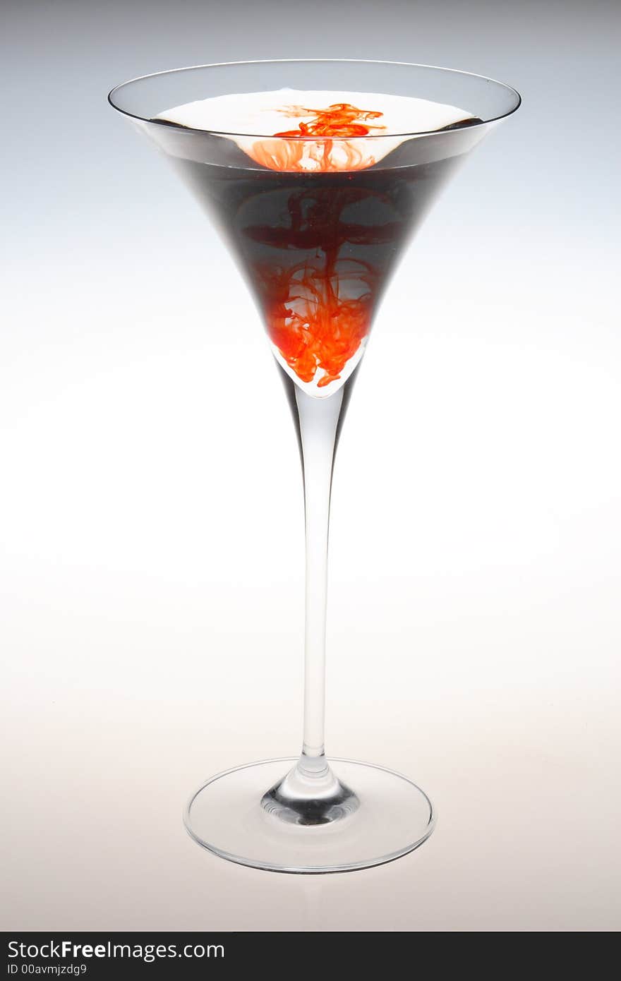 Tall martini glass with red splater color. Tall martini glass with red splater color