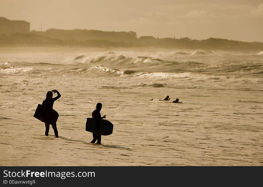 Sunset bodybarders in the beach