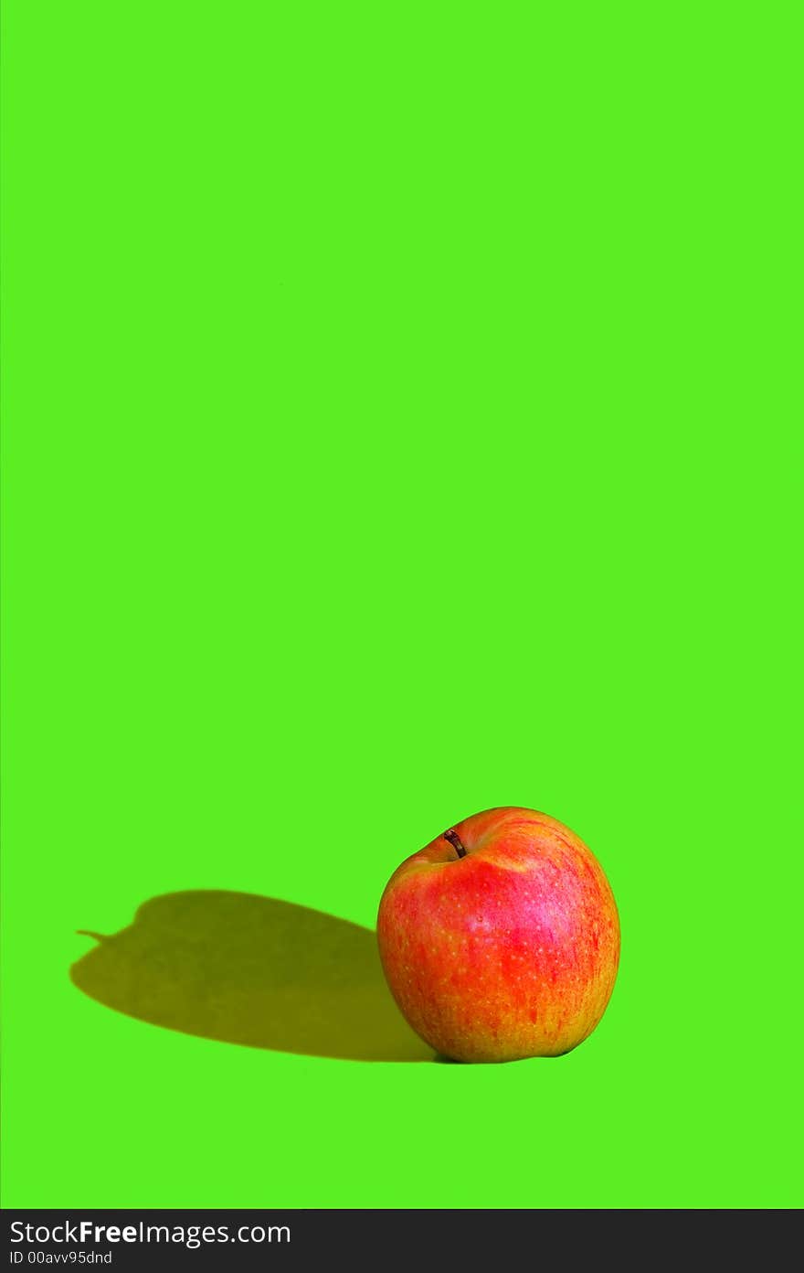 Photo of red apple on green background