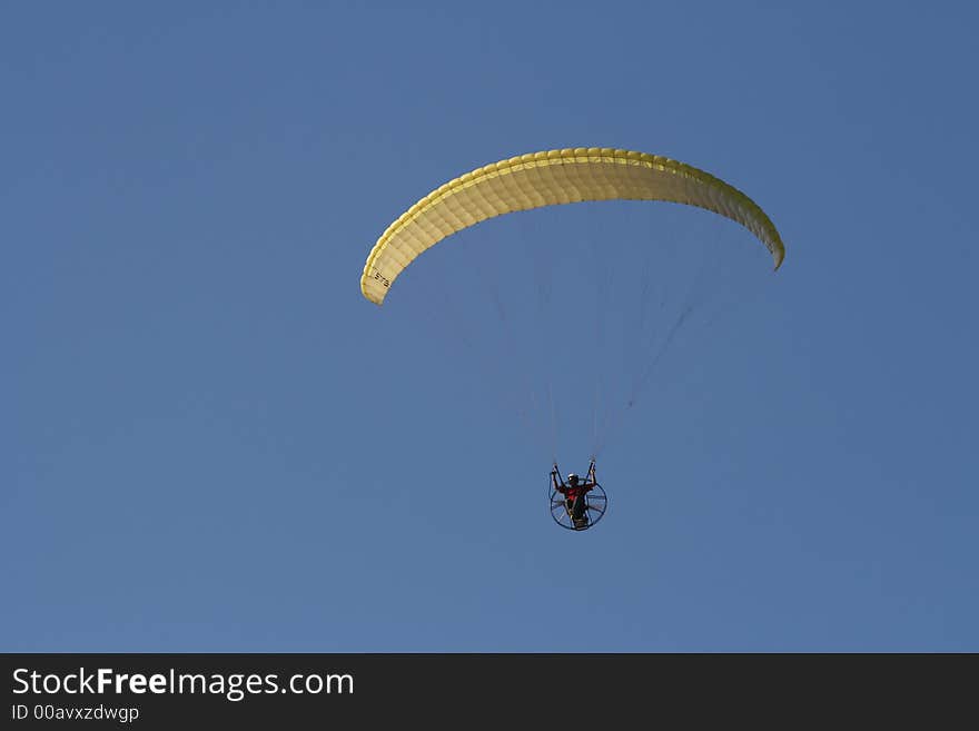 Paraglider with engine over a blue sky . Paraglider with engine over a blue sky