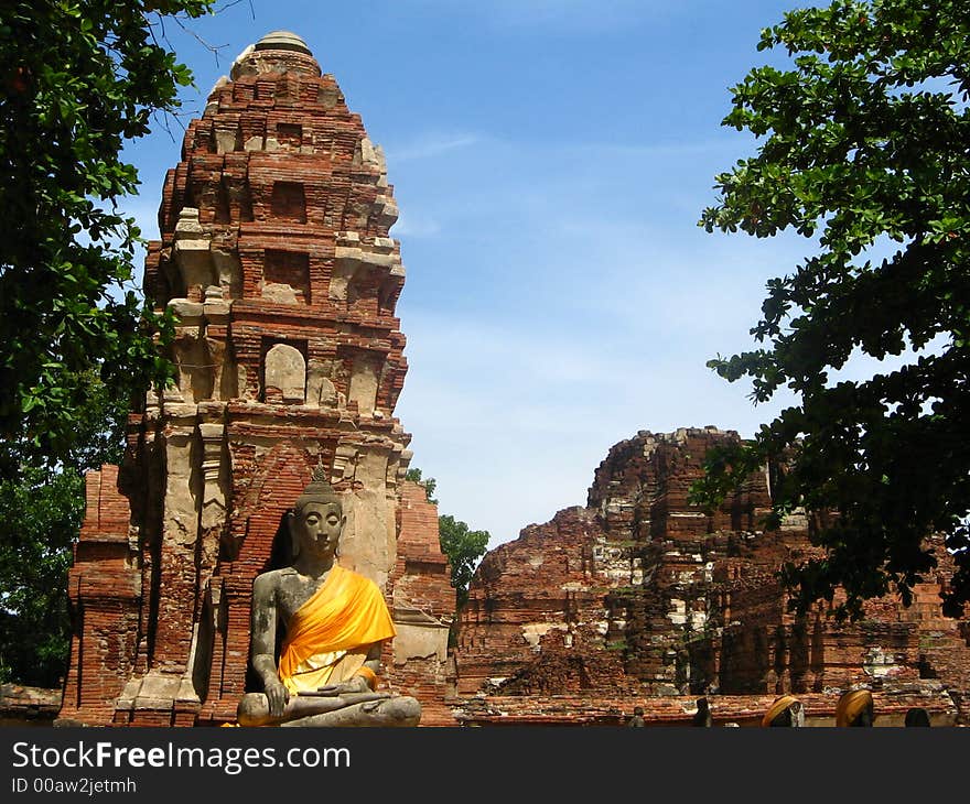 Meditating buddha statue with yellow wrap