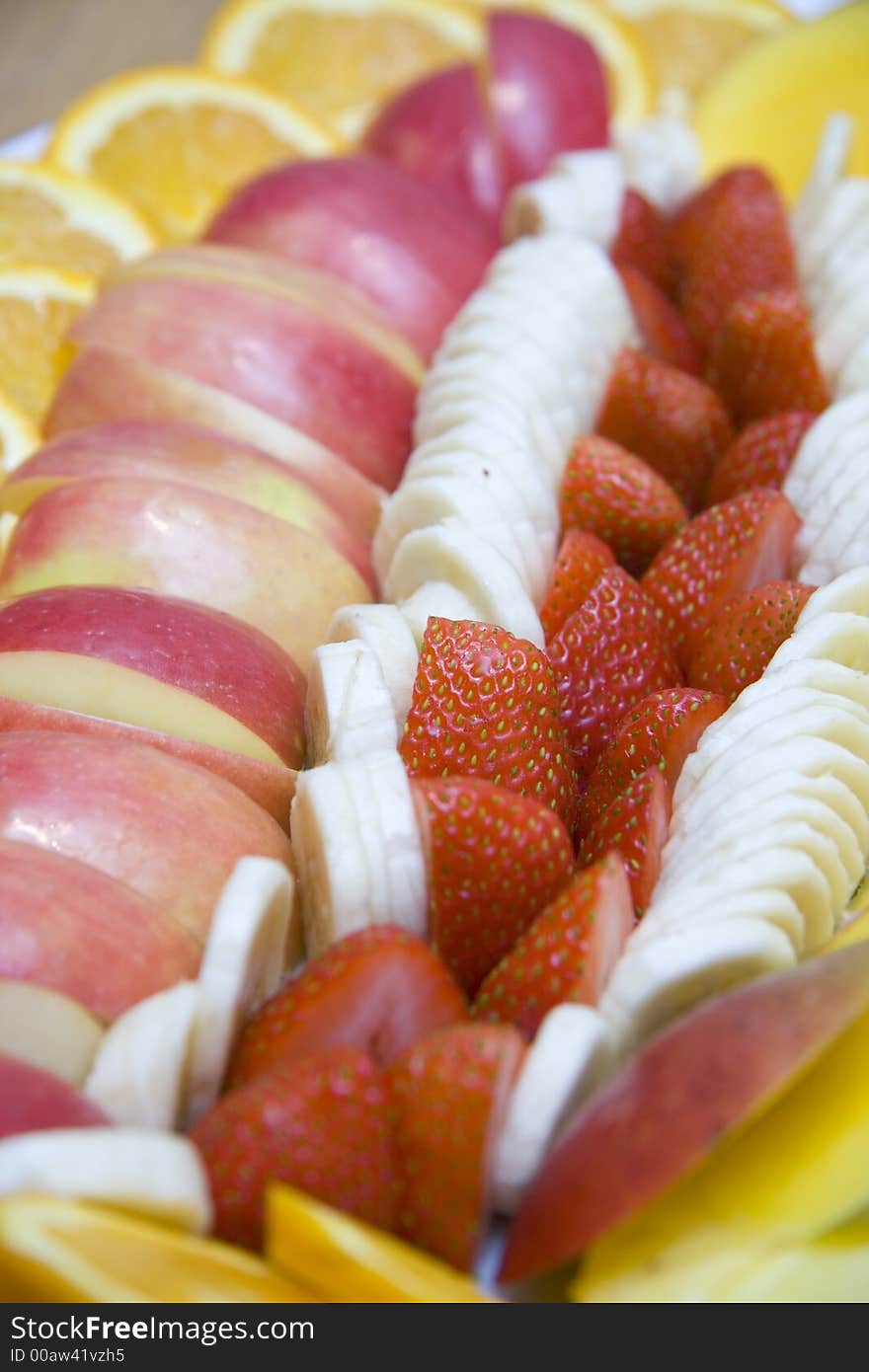 Assorted fruit arranged on a serving plate at holiday table. Assorted fruit arranged on a serving plate at holiday table