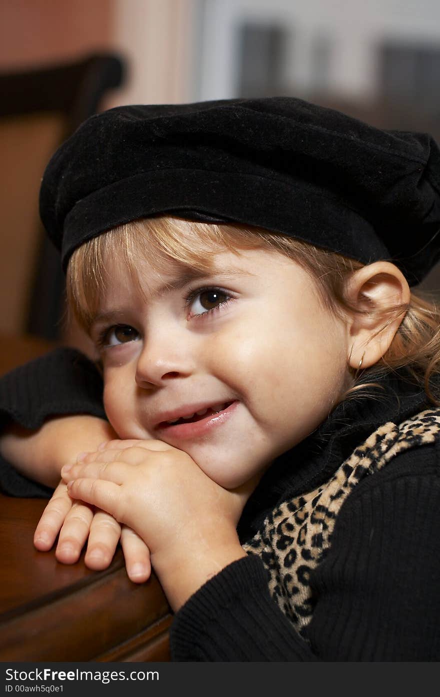 Young girl with hat smiling