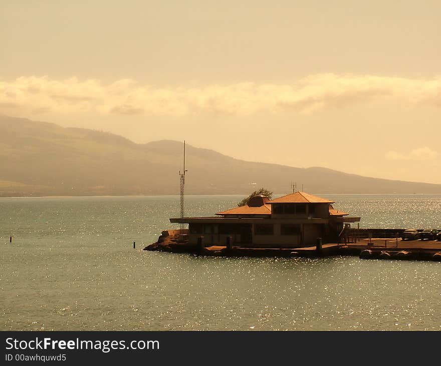 View of a pier at oceanic bay, view of mountains in the background. View of a pier at oceanic bay, view of mountains in the background