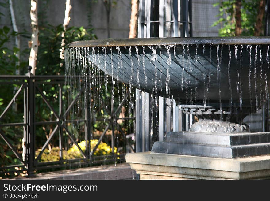 A relaxing water fountain.  Water flowing over the edge. A relaxing water fountain.  Water flowing over the edge.