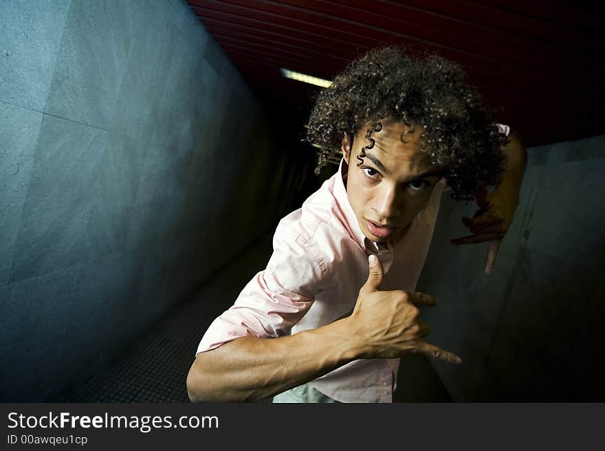 Guy standing in a tunnel preventing people from entering. Guy standing in a tunnel preventing people from entering