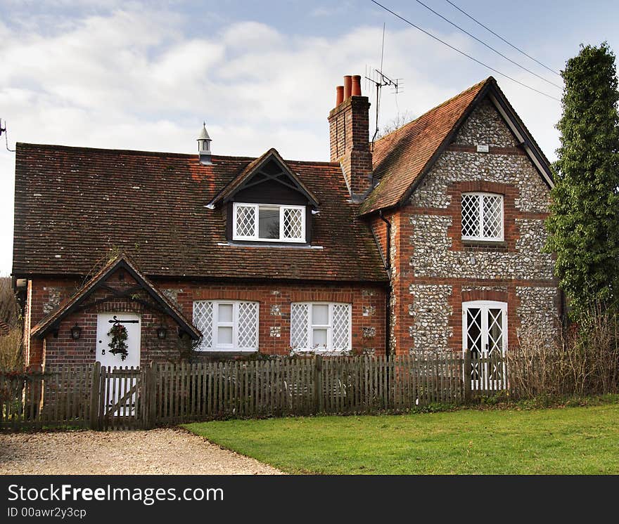 Winter scene of a Brick and Flint Village House in Rural England. Winter scene of a Brick and Flint Village House in Rural England